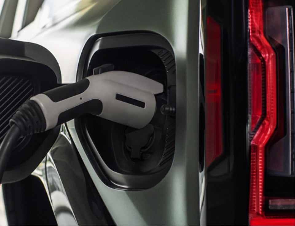 Close up of charging port with charger plugged in on a GMC Hummer EV SUV - Langley GMC in Lanett, AL 36863 AL